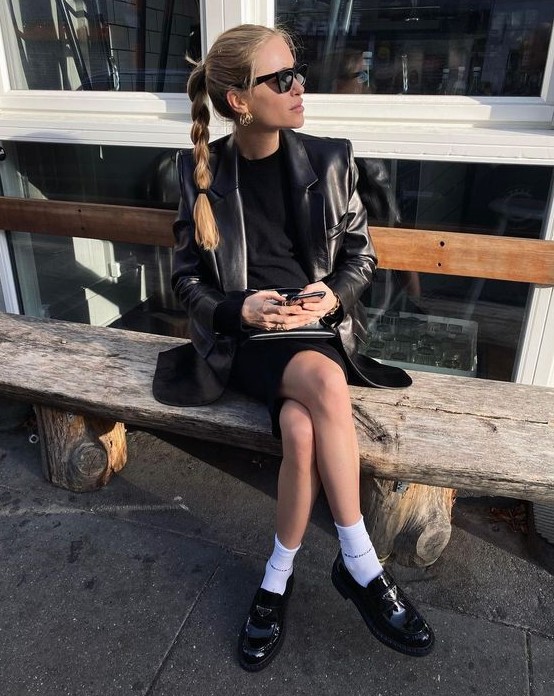 a black mini dress, a black leather jacket, white socks and black chunky loafers for a statement look