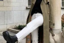 a black turtleneck, white jeans, black chunky boots, a green trench and a black bag plus statement earrings