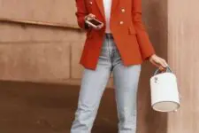 a bright fall outfit with a white t-shirt, light blue jeans, white kitten heel booties, a rust blazer and a white bucket bag