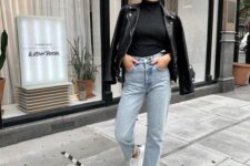 a classy and simple fall outfit with a black turtleneck and a leather jacket, bleached mom jeans and white sneakers