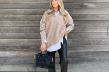 a cozy and chic work outfit with a white oversized shirt, a tan jumper, black leather trousers, black lacquer loafers and a bag