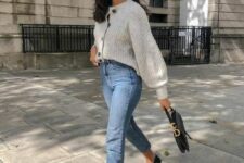 a cozy classic fall outfit with blue mom jeans, a neutral tucked in cardigan, black loafers and a black bag
