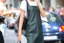 a white t-shirt, a dark green leather pinafore dress and a black bag are all you need for a lovely fall look