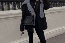 black leggings, a black top and blazer, loafers and a bag plus a grey sweater over the shoulders for a touch of freshness