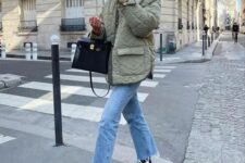 blue mom jeans, an olive green quilted jacket, black sneakers and a black bag compsoe a cool everyday look