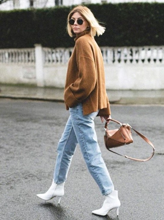 a brown oversized sweater, blue jeans, white booties and a brown bag compose a simple fall look
