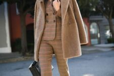 02 a brown plaid pantsuit with cropped pants, a brown faux fur coat, a black bag and brown shoes
