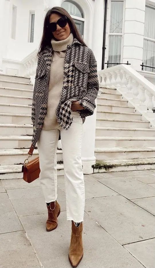 a creamy sweater, a plaid shirt jacket, white jeans, brown boots and a brown bag for maximal comfort