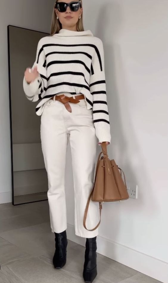 a striped sweater, white cropped jeans, black boots, a beige belt and a beige bag are a nice combo for the fall or Thanksgiving