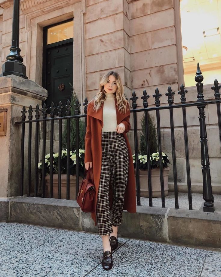 a pretty work outfit with a neutral turtleneck, brown plaid trousers, a brown coat, black loafers and a brown bag