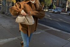 11 a white sweater, a brown shacket, blue jeans, beige Chelsea boots and a creamy clutch for Thanksgiving