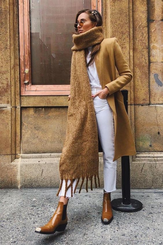 a white t-shirt and cropped jeans, brown Chelsea boots, a mustard trench, a matching oversized scarf
