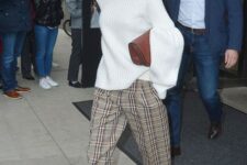 14 a trendy look by Victoria Beckham – a white oversized sweater, plaid cropped pants and neutral shoes plus a burgundy bag
