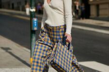 15 a whimsy and bright outfit with a neutral top, colorful plaid wideleg pants and a matching bag for the fall