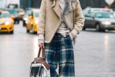 17 a winter look with a neutral turtleneck, plaid wideleg pants, black boots, a neutral shearling coat and a fringe bag