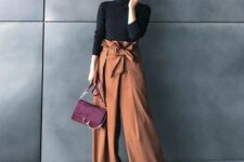 19 a black turtleneck, rust-colored high waisted wideleg pants, black shoes and a burgundy bag