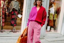 21 a catchy and bold Thanksgiving outfit with pink velvet pants, trainers, a pink and red cardigan and a quilted bag