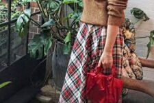 22 a brown sweater, a bold plaid pleated midi, vintage brown shoes and a red bag for pulling off a vintage holiday look