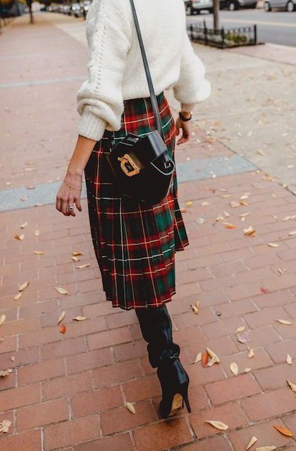 a cozy white sweater, a plaid pleated midi skirt, black boots and a black bag for a cozy look