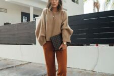 27 a simple outfit with a tan cropped sweater, rust-colored pants, mustard shoes and a black printed bag