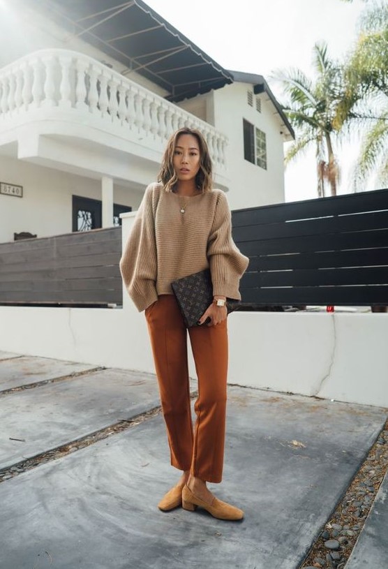 a simple outfit with a tan cropped sweater, rust-colored pants, mustard shoes and a black printed bag