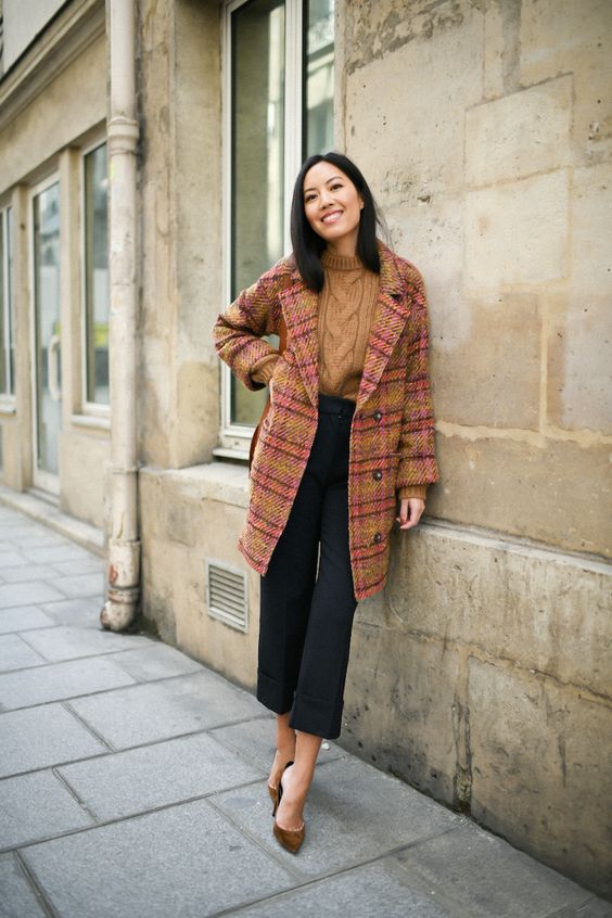 a mustard patterned sweater, black cropped pants, a bold mustard plaid coat, brown velvet shoes