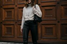 With beige cardigan, black leather bag and beige and black suede ankle boots
