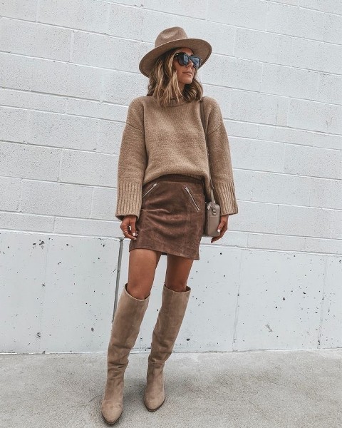With beige wide brim hat, oversized sunglasses, beige leather bag and beige over the knee boots