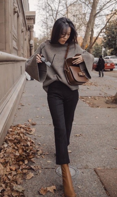 With black flare cropped pants, brown leather mid calf boots, sunglasses and brown leather bag