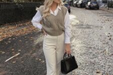 With black leather bag, beige high-waisted cuffed pants and white flat shoes