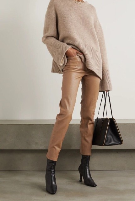 With black leather mid calf heeled boots and black and golden leather bag