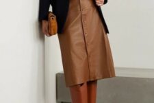 With black long blazer, brown suede clutch and brown leather high boots