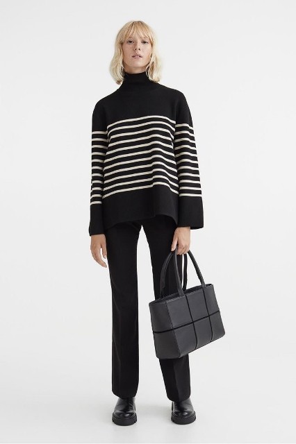 With black trousers, black leather tote bag and black leather flat boots