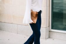 With blue flare jeans, faux fur clutch and beige high heeled boots