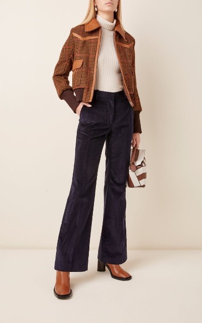 With brown and white leather bag, brown checked jacket and brown leather heeled boots