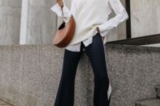 With brown leather bag, black and white flare pants and white heeled boots
