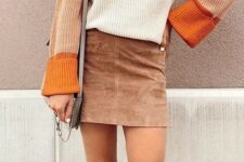 With gray leather bag and beige suede high boots
