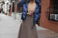 With light brown turtleneck, waist bag, black tights and black leather platform lace up boots