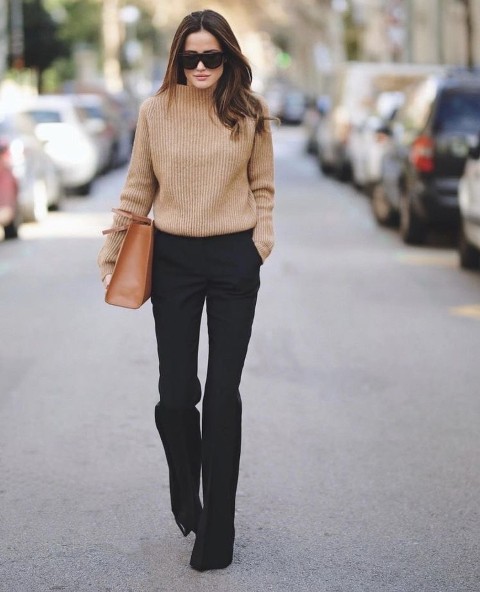 With oversized sunglasses, brown leather bag and black patent leather high heeled boots