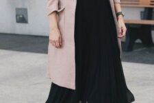 With pale pink midi coat and brown leather high boots