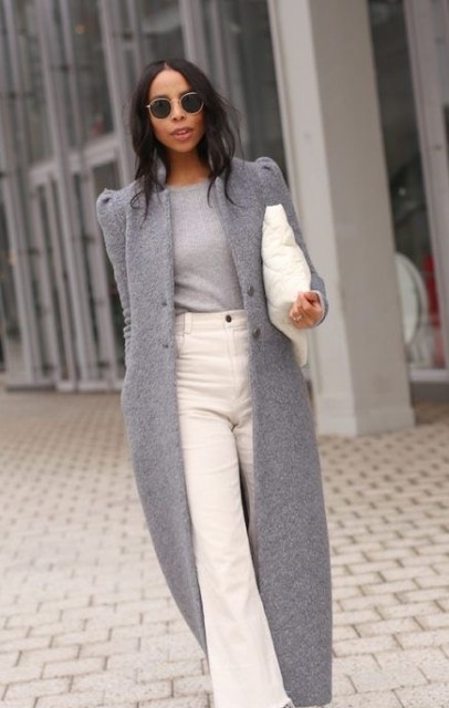 With rounded sunglasses, gray midi coat and white puffer clutch