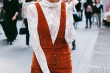 a 70s glam Thanksgiving outfit wiht a white lace top, a burnt orange velvet pinafore mini dress is wow