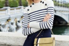 a Breton stripe jumper with black buttons, a navy mini skirt, a gold striped bag on chain are a great combo