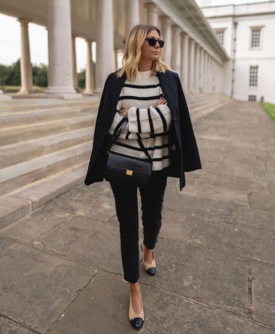 a Breton stripe sweater, black jeans, a black blazer, two tone shoes and a black bag for work