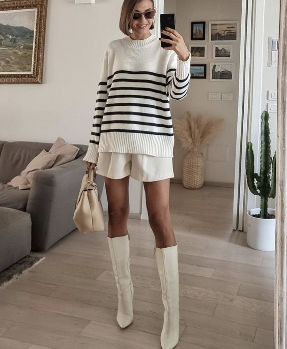a Breton stripe sweater, white shorts, white knee boots, a neutral bag are a perfect and chic look for the fall