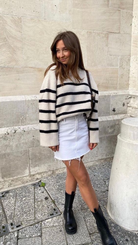 a Breton sweater, a white denim mini, black chunky boots and a brown bag are a great and chic combo