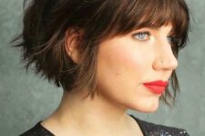 a black jaw-length bob with a shaggy texture and a classic fringe is a stylish idea that looks effortless and cool