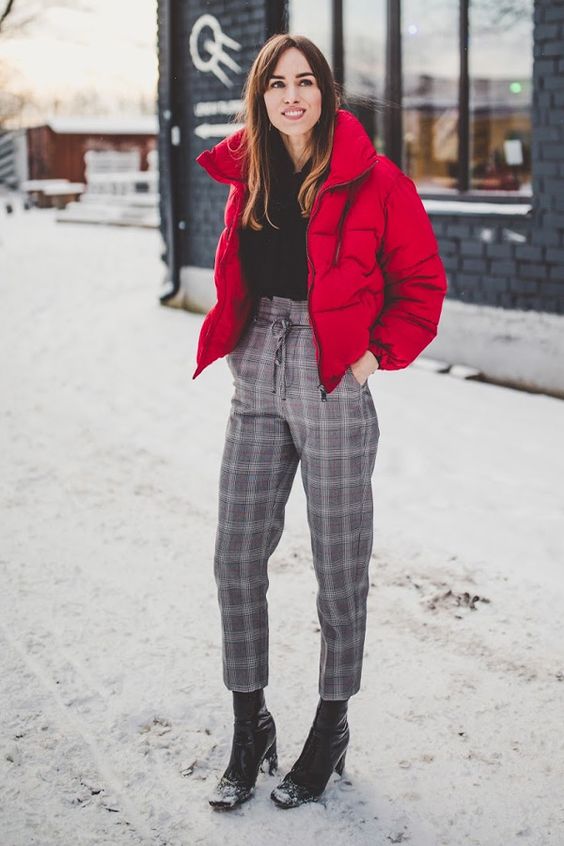 a black sweater, grey plaid cropped pants, black heeled boots, a hot red cropped puffer jacket