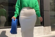a bold Thanksgiving outfit with an emerald cropped sweater, a creamy midi skirt, matching boots and a blue bag