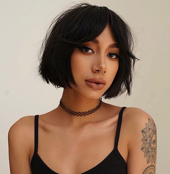 a chin-length black bob with textured hair and bottleneck bangs is a very edgy and hot idea